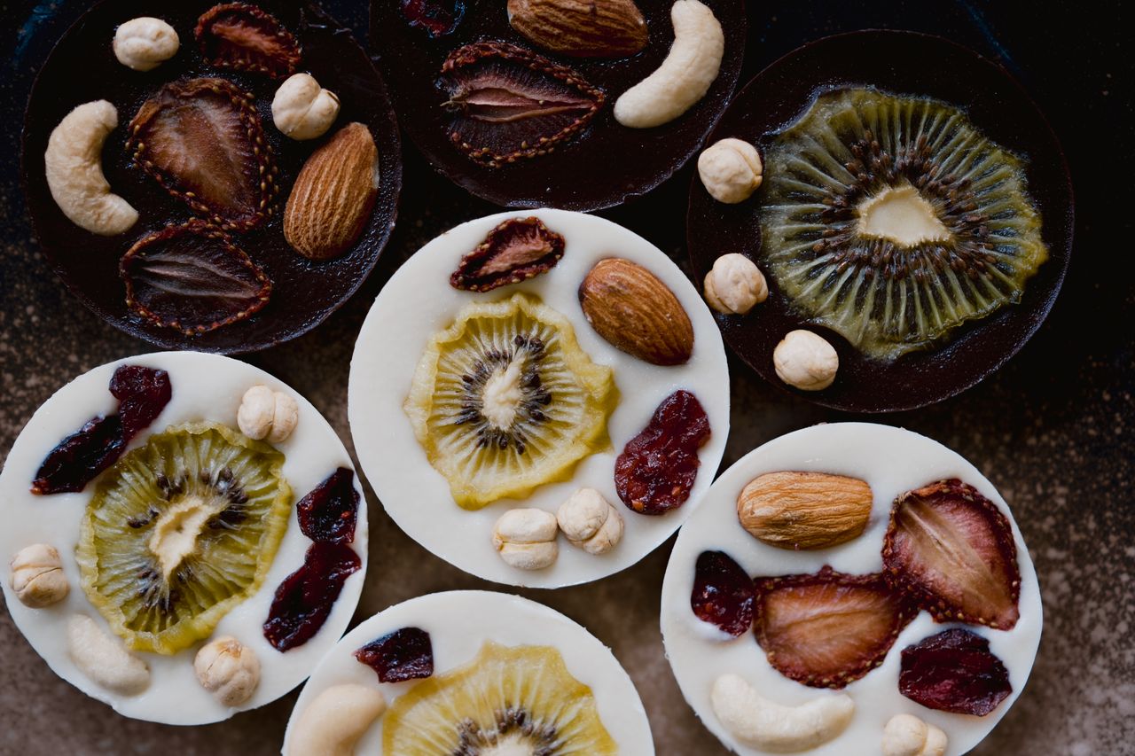 About Vibrant chocolate discs topped with fresh fruit and nuts create a mouthwatering display.