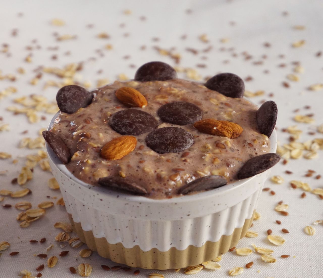 Tasty homemade oatmeal dessert with chocolate chips and almonds, perfect for a sweet breakfast or snack.